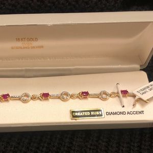 Created Ruby and diamond accent tennis bracelet. 18 kt gold over sterling silver